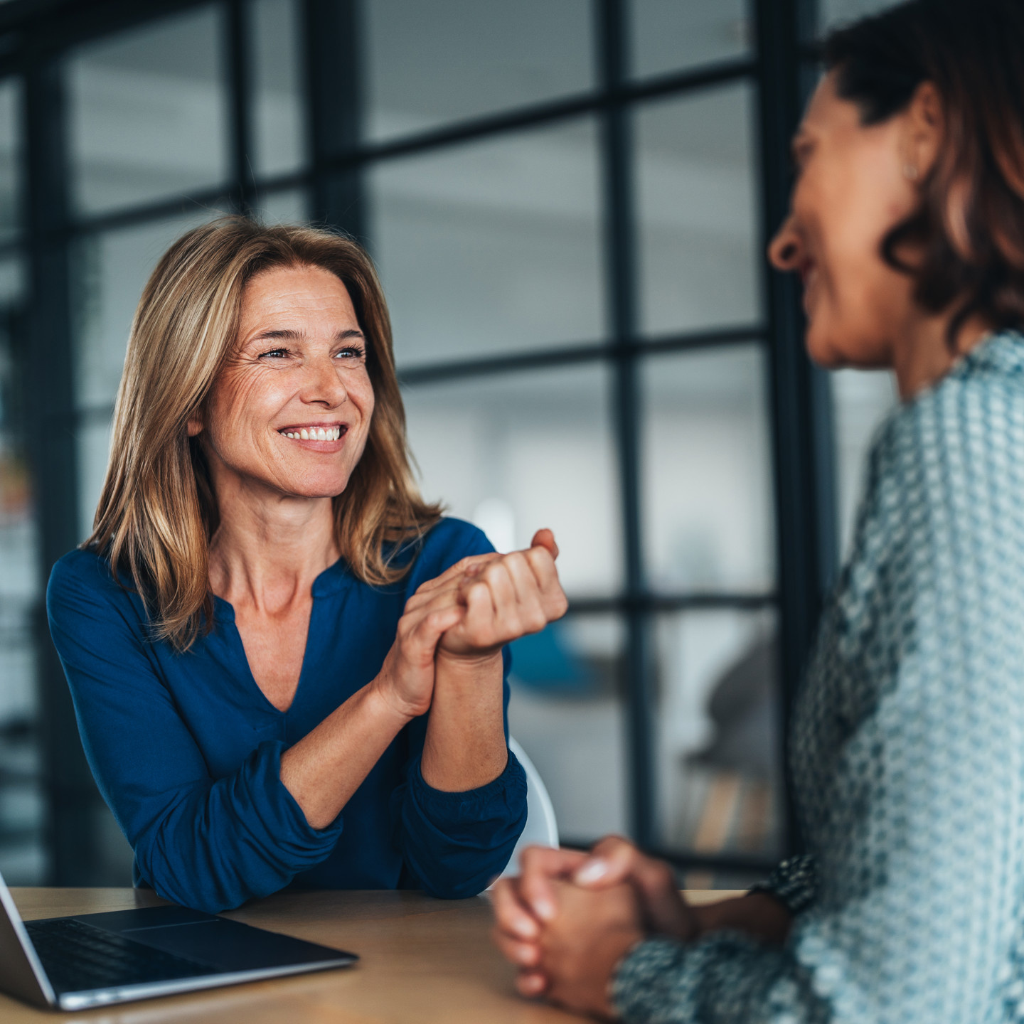 Two Women Smiling And Chatting