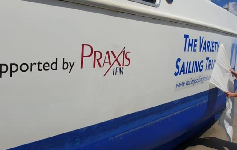 An image of a boat with the Praxis IFM logo printed on it as a sponsor