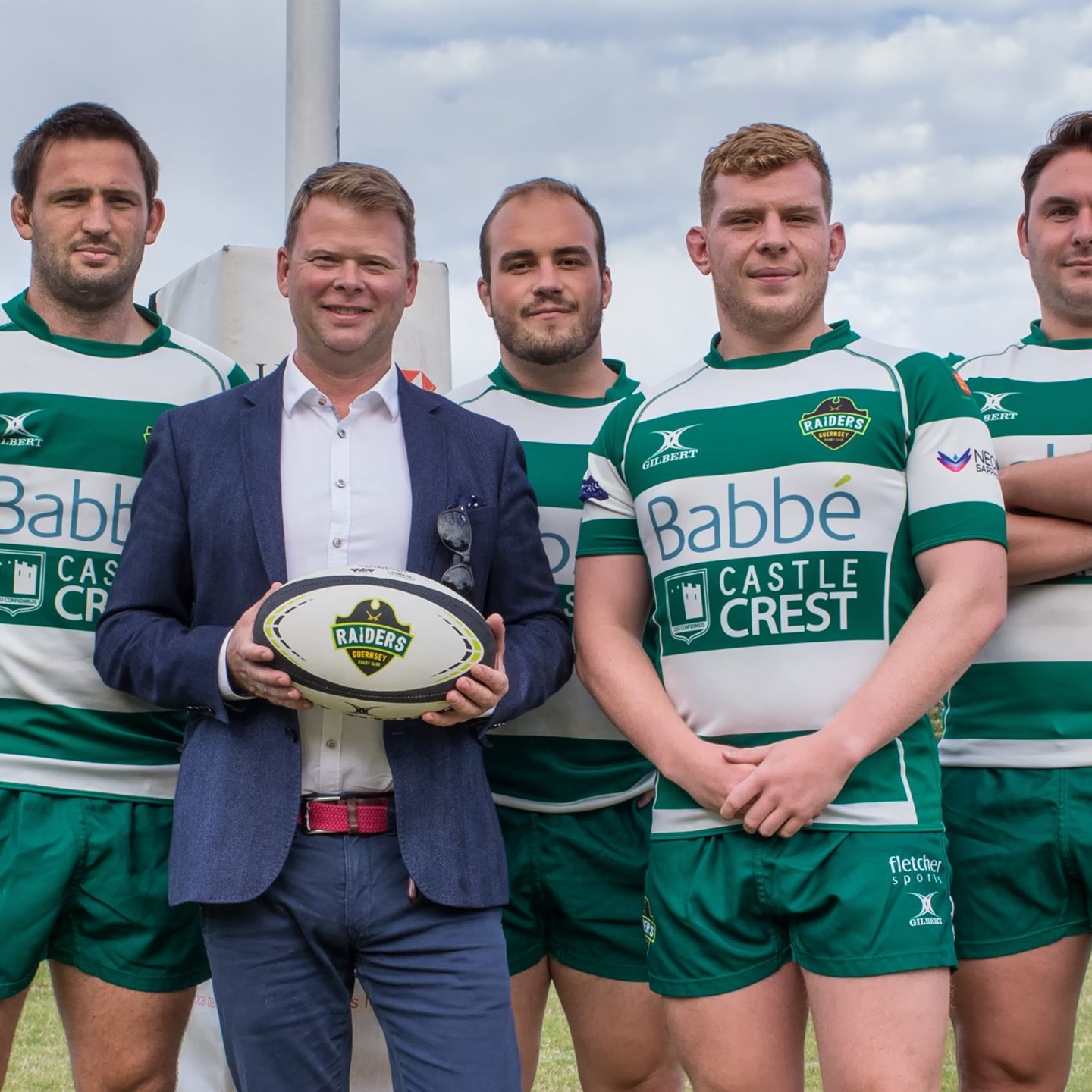 Matt Litten posing with 4 of the Guernsey Raiders rugby team on the Rugby field