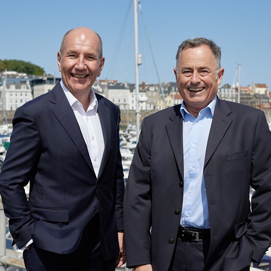 Rob Fearis and Tim Joyce in front of boats in St Peter Port harbour
