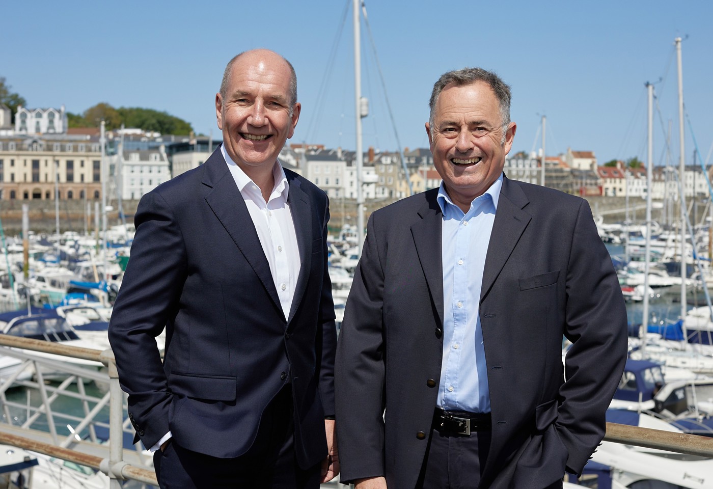 Rob Fearis and Tim Joyce in front of boats in St Peter Port harbour