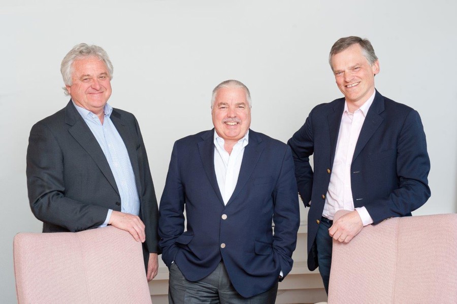 Brian Morris, Martyn Crespel and Simon Thornton posing for a professional photograph behind chairs.