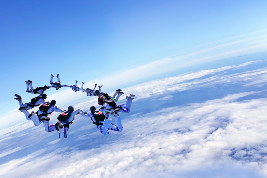 A group of sky divers making a circle while free-falling