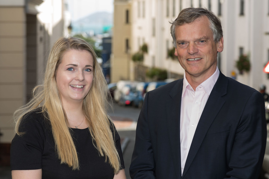 Simon Thornton and Tilly Ayes (Bursary Student) standing side-by-side for a photo outside the Guernsey office.