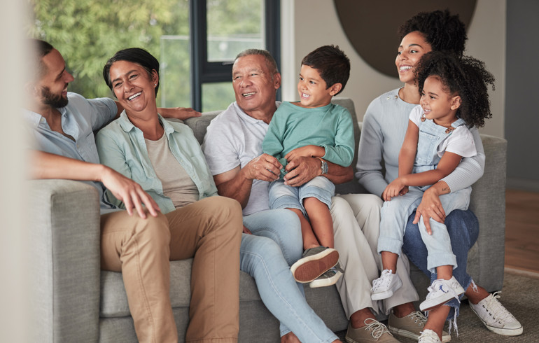 Family Relaxing On A Sofa | Praxis