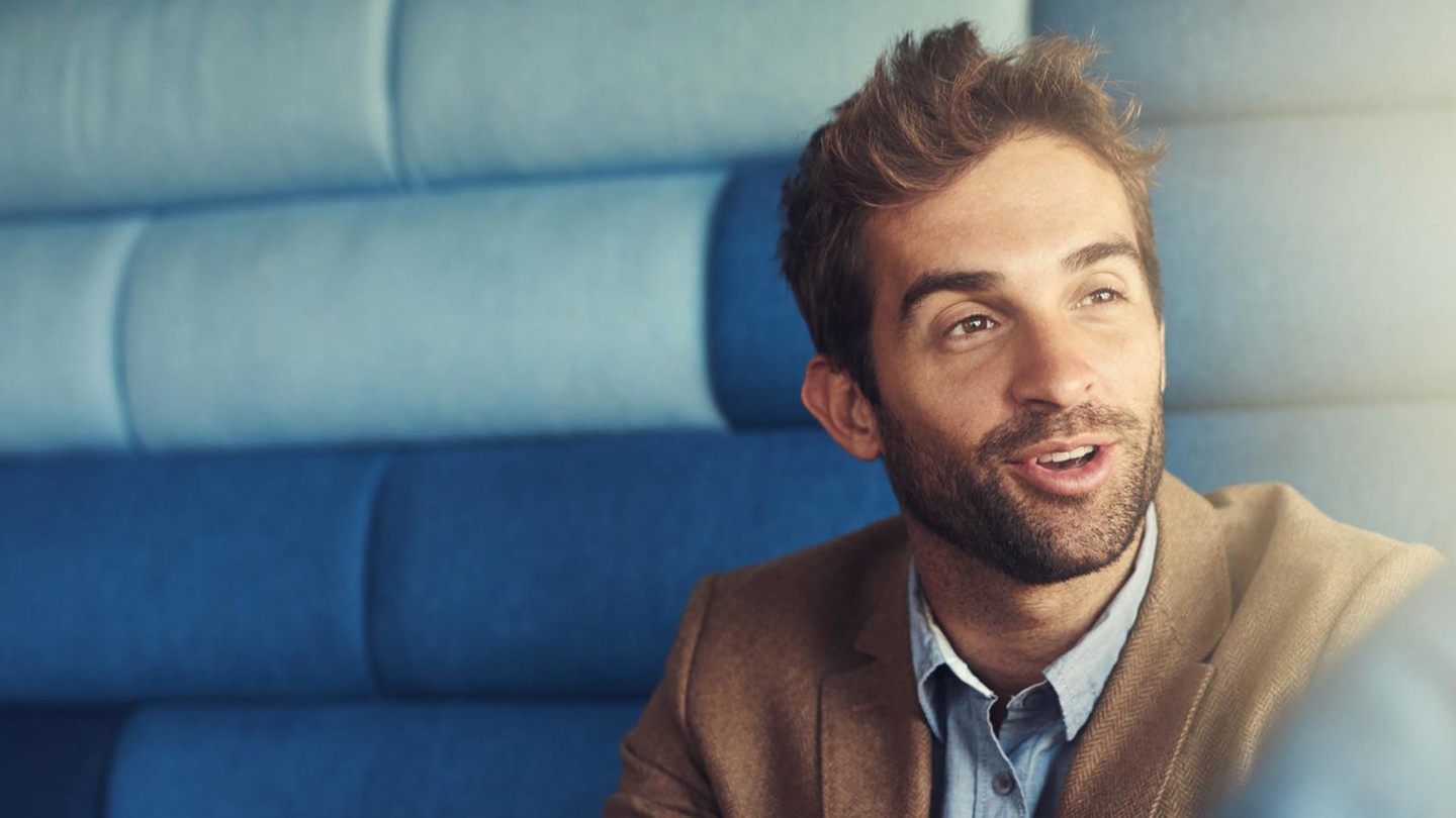 An image of a man with a beard having a discussion with someone behind the camera
